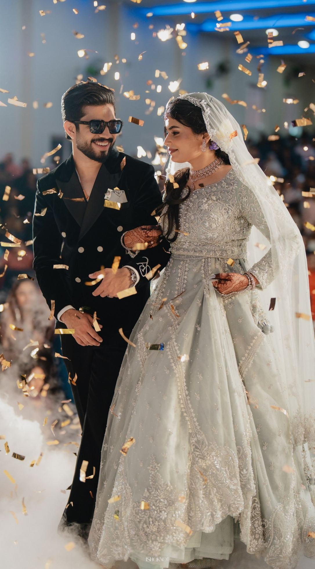 Bride and groom making their grand entrance through confetti