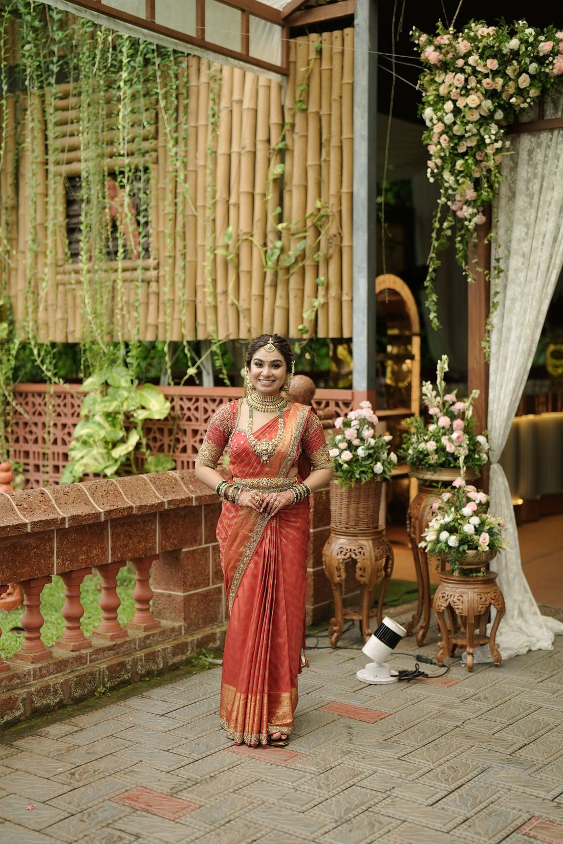 Bride in a red saree among flowers